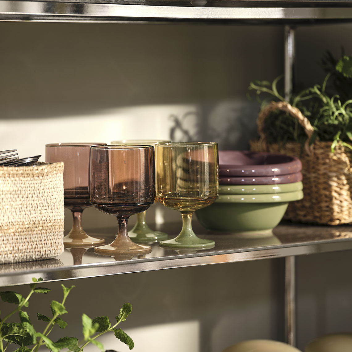 Colourful glasses and bowls on a shelf