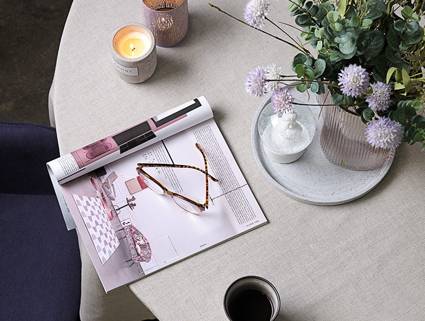 Table with vase and candles, magazine and glasses Table with vase and candles, magazine and glasses