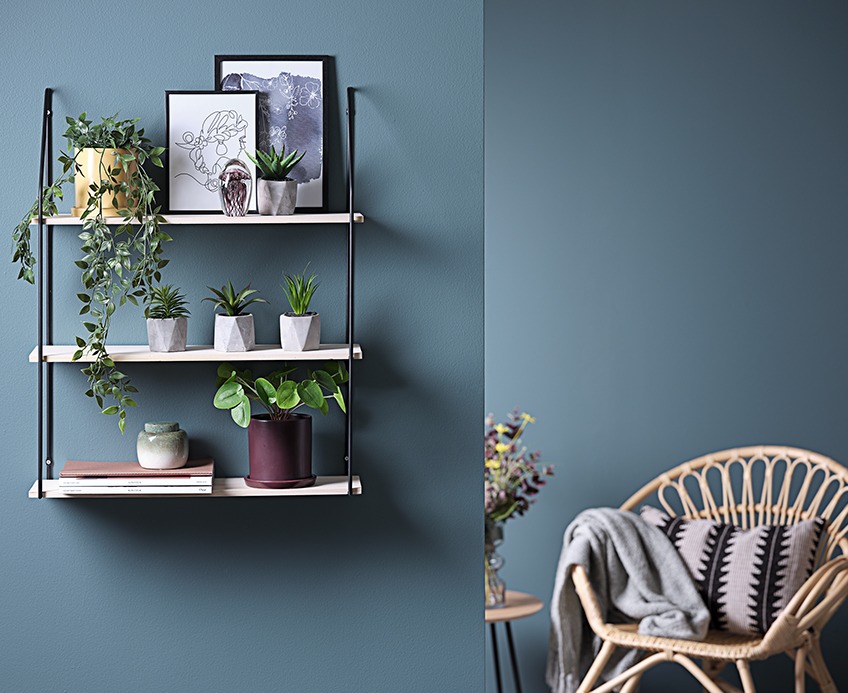 Artificial plants on a shelf in living room Artificial plants on a shelf in living room