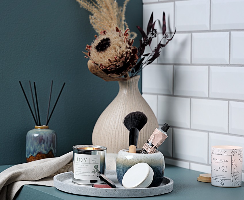 Tray with vase, scented candles and make up gear in bathroom Tray with vase, scented candles and make up gear in bathroom