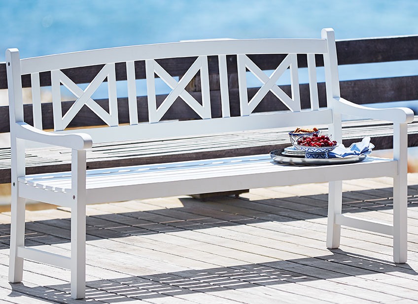 White wooden garden bench on a patio  