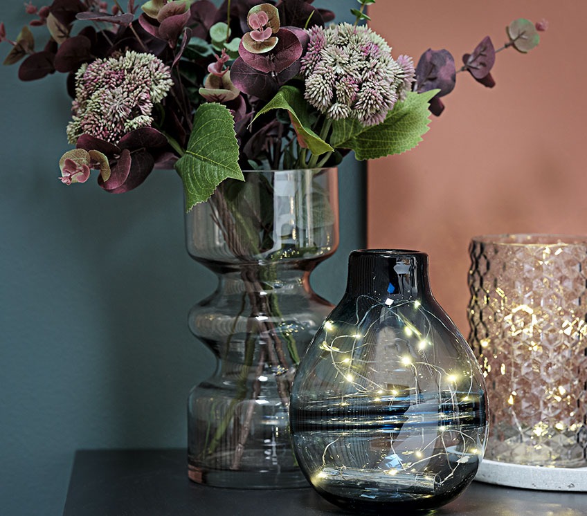 Collection of vases with light strings and artificial flowers 