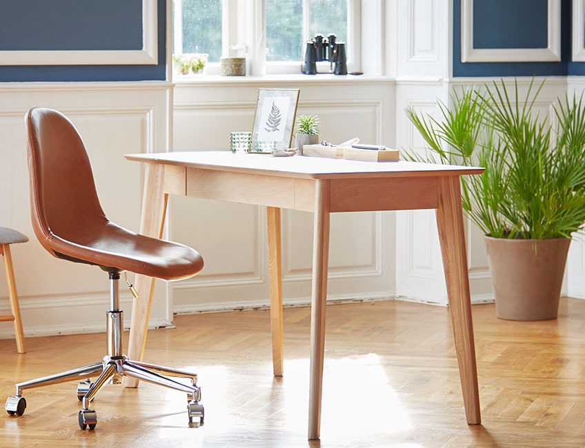 Oak desk and leather office chair in a classy room 