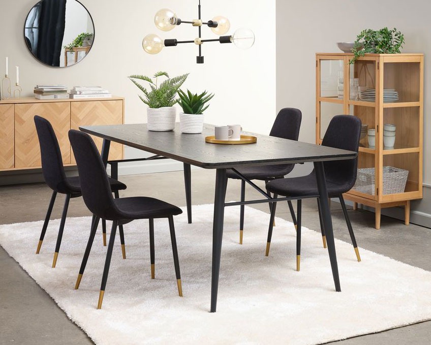Black fabric dining chairs in Scandinavian design with gold dipped chair legs