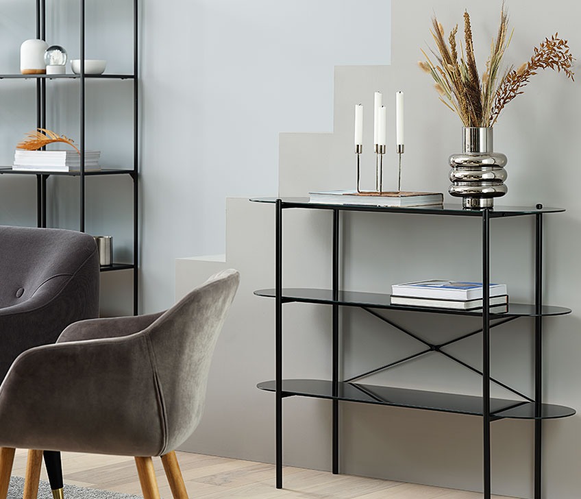 Metal bookshelf with stack of books 