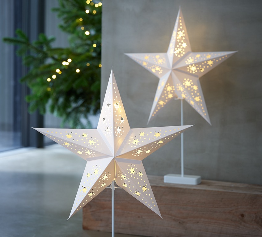 Two battery lamps shaped as white Christmas stars 