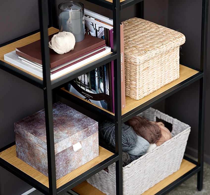 Asymmetrical bookcase with wicker storage boxes 