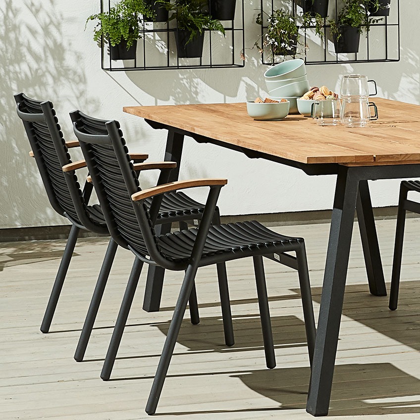 SADBJERG stacking chair with seat and backrest out of recycled ocean plastic and armrest out of FSC certified teak Garden stacking chairs with seat and backrest out of recycled ocean plastic