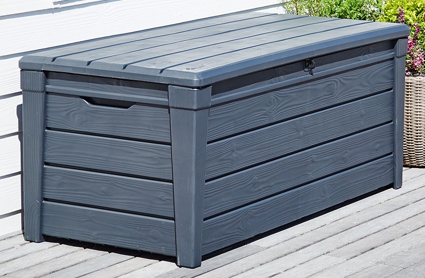 SVENDBORG cushion box can also be used as a bench Grey cushion box on a wooden patio