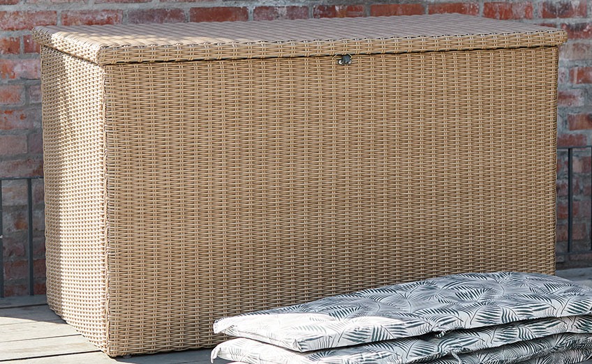 TAMBOHUSE cushion box is also available in black Large garden storage box on a wooden patio