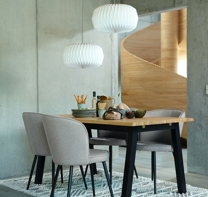 Dining table with four dining chairs in grey with black legs and two white pendants Dining table with four dining chairs in grey with black legs and two white pendants