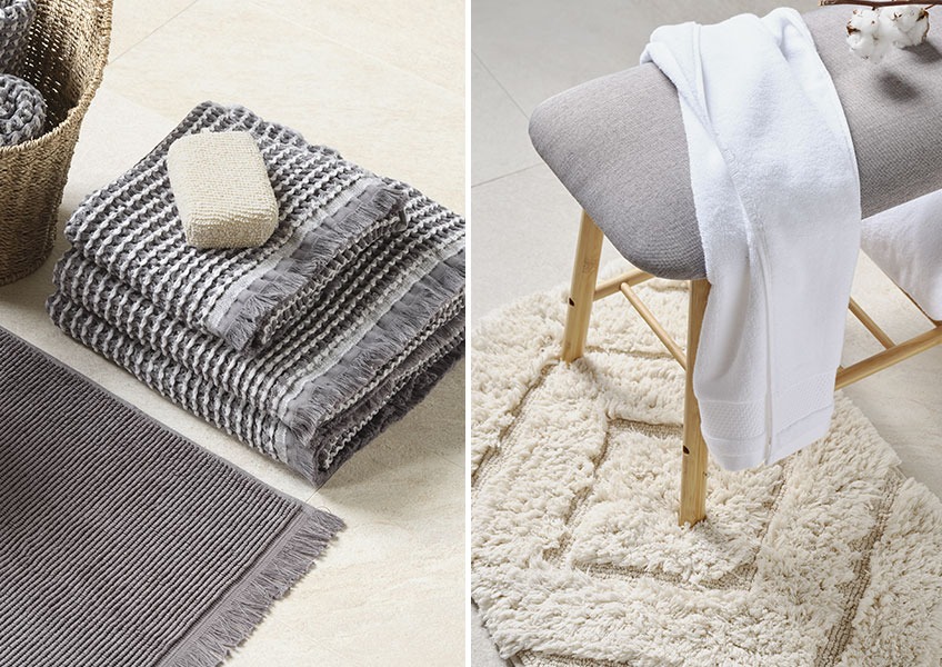 Grey waffle towels and white towel on bench placed on off white bath mat