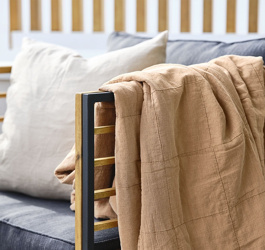 Lounge chair with orange quilted blanket