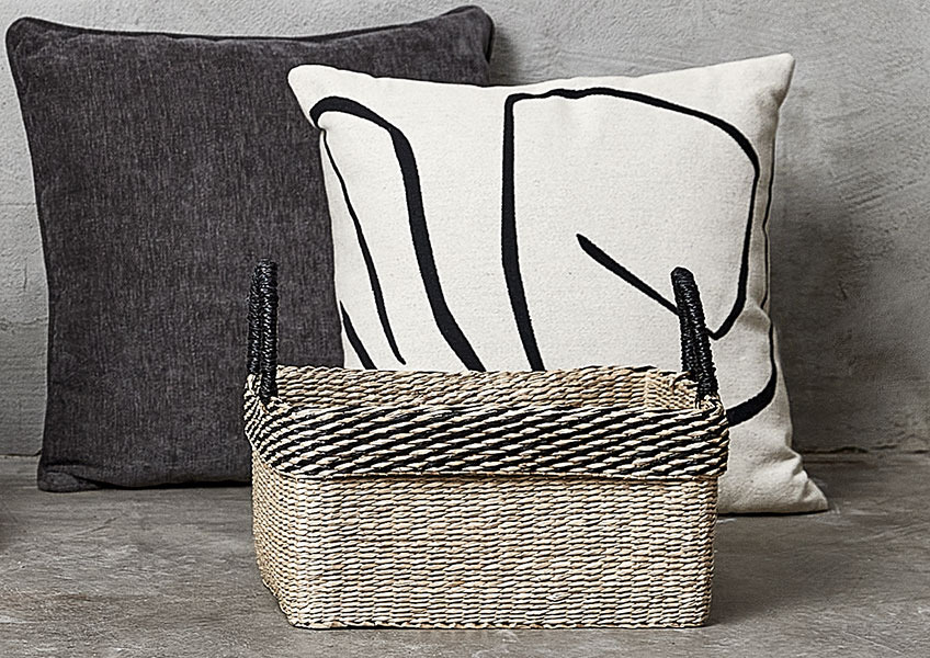 Two cushions in white, beige, and grey colours and basket