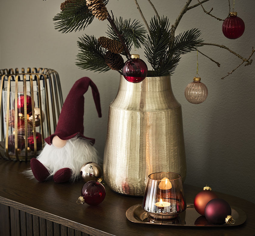 Golden candlestick, Christmas elves and golden vase with spruce branches and Christmas baubles 