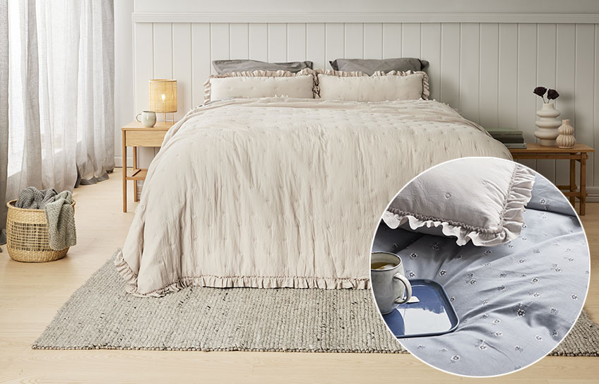 Bedroom with beige bedspread and back cushions 