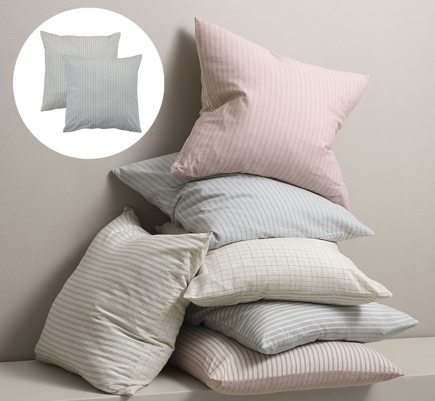GULDREGN cushion covers in different colours Cushions stacked on top of each other