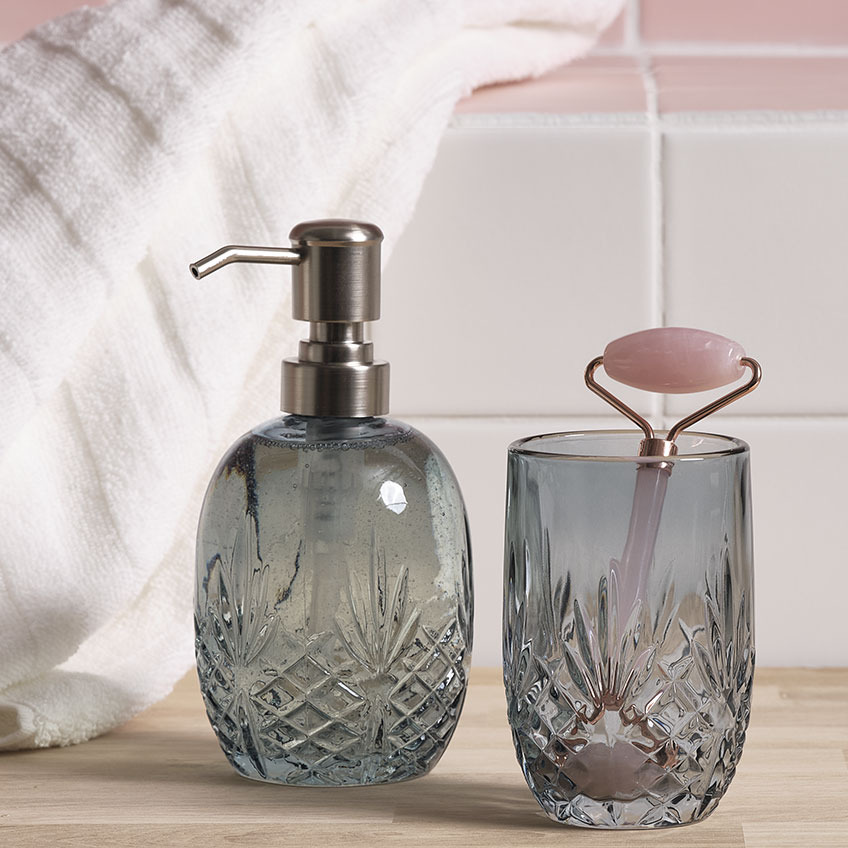 EDSVALLA soap dispenser and toothbrush holder and VALLSTA face roller Soap dispenser and toothbrush holder with face roller in a bathroom